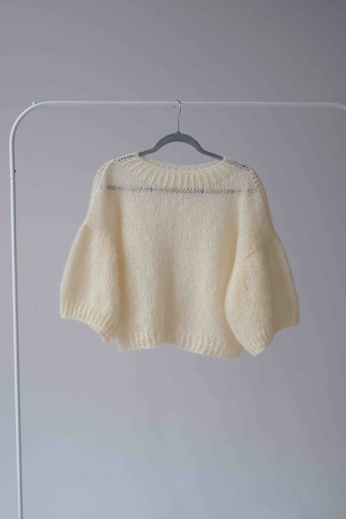 Wełniany, cytrynowy sweter Sirka&PG Clothes na wieszaku