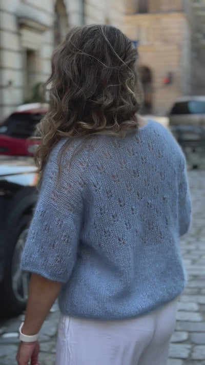 Kobieta prezentująca błękitną  bluzeczkę Ewa Sirka handmade
